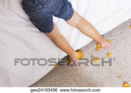 Low section view of a boy leaning over the bed View Large Photo Image Stock Photograph - Low section view of a boy leaning over the bed. Fotosearch