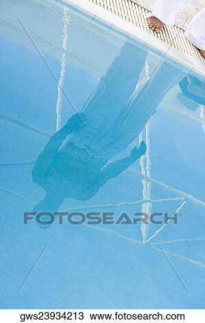 Low section view of a mid adult man standing at the edge of a swimming pool View Large Photo Image Stock Image - Low section view of a mid adult man standing at the edge of a swimming pool. Fotosearch