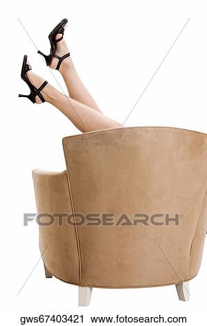 Low section view of a woman on an armchair View Large Photo Image Stock Image - Low section view of a woman on an armchair. Fotosearch