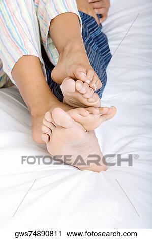 Low section view of a young couple lying on the bed View Large Photo Image Stock Image - Low section view of a young couple lying on the bed. Fotosearch