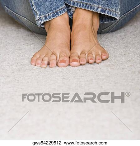 Low section view of a young woman sitting on the floor View Large Photo Image Stock Image - Low section view of a young woman sitting on the floor. Fotosearch