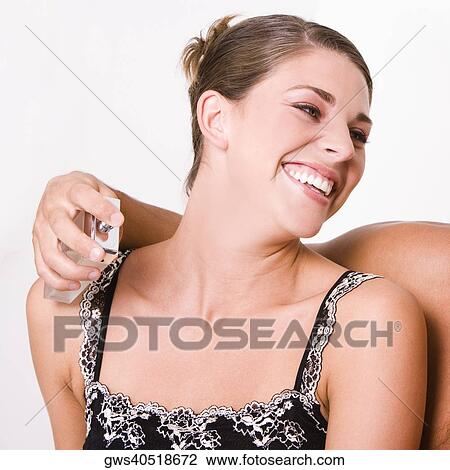Man's hand spraying perfume on a young woman View Large Photo Image Stock Image - Man's hand spraying perfume on a young woman. Fotosearch
