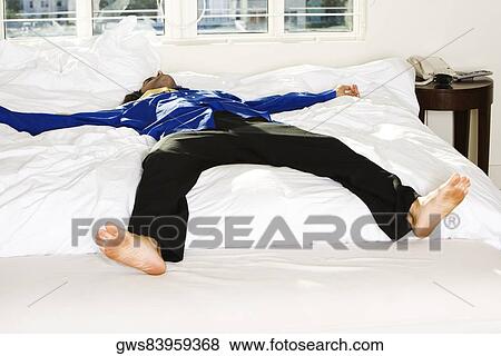 Mid adult man lying on the bed View Large Photo Image Stock Photo - Mid adult man lying on the bed. Fotosearch