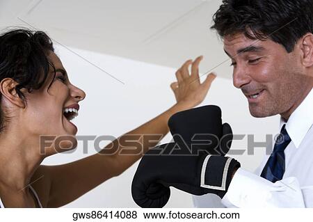 Mid adult man wearing boxing gloves View Large Photo Image Stock Photo - Mid adult man wearing boxing gloves. Fotosearch