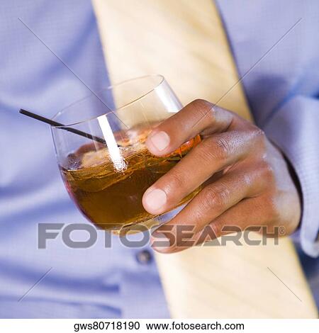 Mid section view of a businessman holding a glass of wine View Large Photo Image Stock Image - Mid section view of a businessman holding a glass of wine. Fotosearch