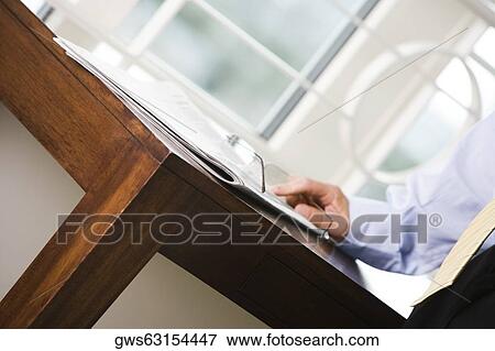 Mid section view of a businessman standing near a table View Large Photo Image Stock Photo - Mid section view of a businessman standing near a table. Fotosearch