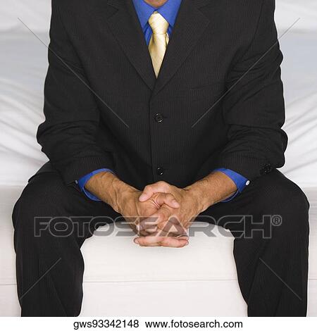 Stock Photo - Mid section view of a businessman sitting. Fotosearch