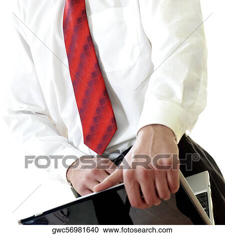 Mid section view of a businessman using a laptop View Large Photo Image Stock Image - Mid section view of a businessman using a laptop. Fotosearch