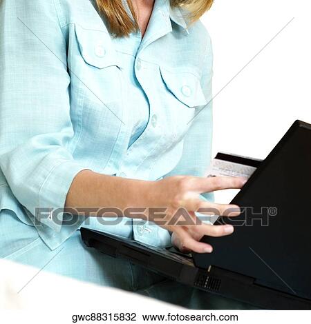 Stock Image - Mid section view of a businesswoman using a laptop. Fotosearch