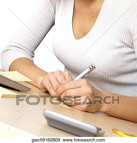 Mid section view of a businesswoman writing on paper View Large Photo Image Stock Photo - Mid section view of a businesswoman writing on paper. Fotosearch