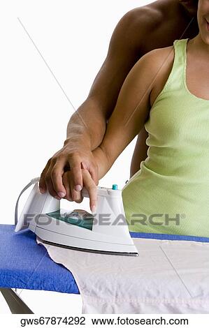 Mid section view of a couple ironing on an ironing board View Large Photo Image Stock Image - Mid section view of a couple ironing on an ironing board. Fotosearch