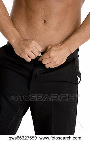 Mid section view of a man buttoning his pants View Large Photo Image Stock Photo - Mid section view of a man buttoning his pants. Fotosearch