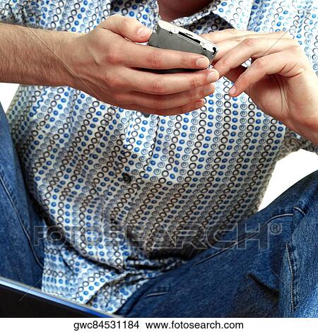 Picture - Mid section view of a man operating a personal digital assistant. Fotosearch