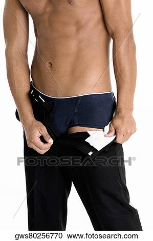 Mid section view of a man taking off his pants View Large Photo Image Stock Image - Mid section view of a man taking off his pants. Fotosearch