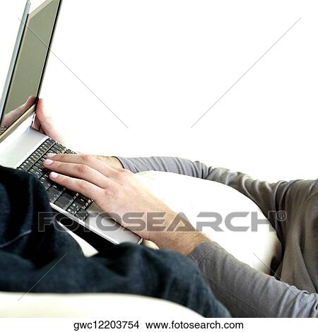Picture - Mid section view of a man using a laptop. Fotosearch