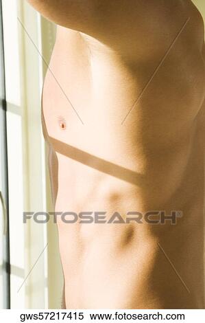 Mid section view of a young man View Large Photo Image Stock Photography - Mid section view of a young man. Fotosearch