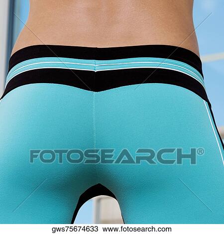 Mid section view of a young woman View Large Photo Image Stock Image - Mid section view of a young woman. Fotosearch