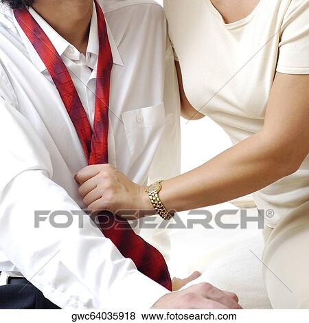 Mid section view of a young woman holding a young man's tie View Large Photo Image Stock Photo - Mid section view of a young woman holding a young man's tie. Fotosearch
