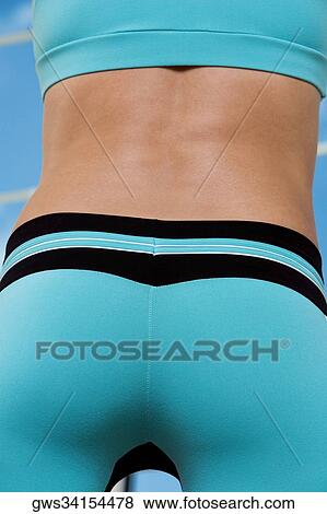Mid section view of a young woman View Large Photo Image Stock Photo - Mid section view of a young woman. Fotosearch