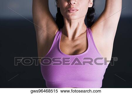 Mid section view of a young woman meditating View Large Photo Image Stock Photography - Mid section view of a young woman meditating. Fotosearch