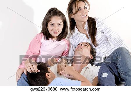 Parents sitting with their son and daughter View Large Photo Image Stock Photo - Parents sitting with their son and daughter. Fotosearch