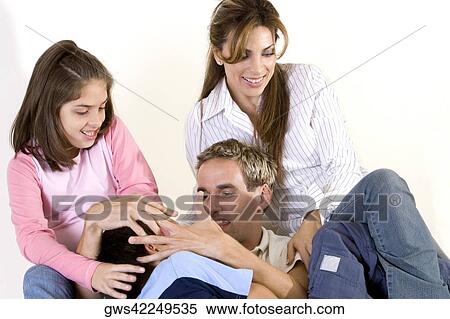 Parents sitting with their son and daughter View Large Photo Image Stock Photography - Parents sitting with their son and daughter. Fotosearch