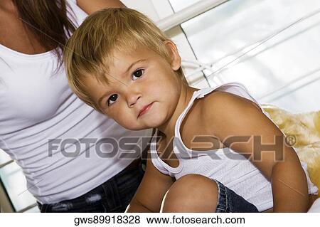 Portrait of a boy sitting on his mother's lap View Large Photo Image Stock Photo - Portrait of a boy sitting on his mother's lap. Fotosearch