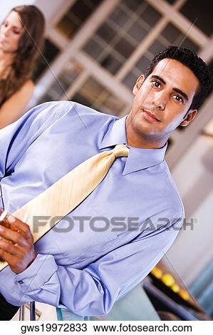 Portrait of a businessman holding a glass View Large Photo Image Stock Image - Portrait of a businessman holding a glass. Fotosearch