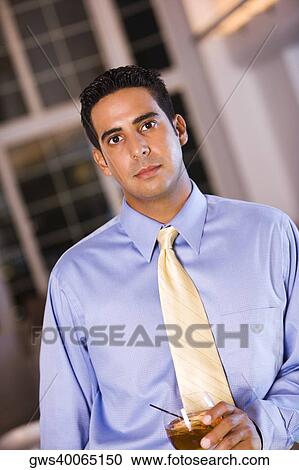 Portrait of a businessman holding a glass of wine View Large Photo Image Stock Image - Portrait of a businessman holding a glass of wine. Fotosearch