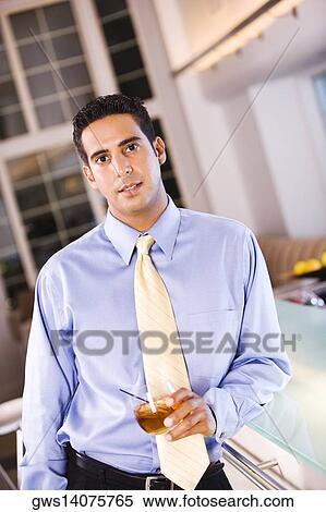 Portrait of a businessman holding a glass of wine View Large Photo Image Stock Photography - Portrait of a businessman holding a glass of wine. Fotosearch