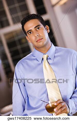 Portrait of a businessman holding a glass View Large Photo Image Stock Photography - Portrait of a businessman holding a glass. Fotosearch