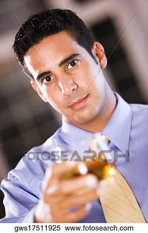 Portrait of a businessman holding a glass of wine View Large Photo Image Stock Photography - Portrait of a businessman holding a glass of wine. Fotosearch