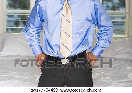 Portrait of a businessman standing with his hands in his pockets View Large Photo Image Stock Photo - Portrait of a businessman standing with his hands in his pockets. Fotosearch