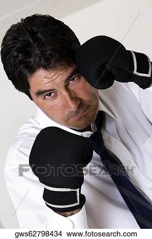 Portrait of a businessman wearing boxing gloves View Large Photo Image Picture - Portrait of a businessman wearing boxing gloves. Fotosearch