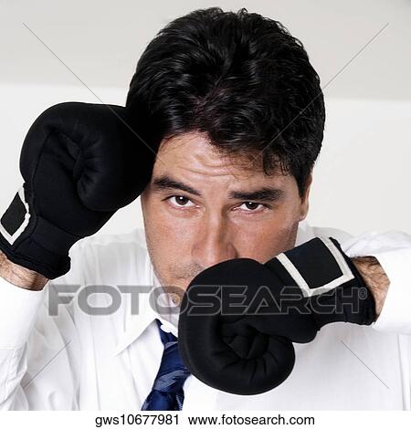 Portrait of a businessman wearing boxing gloves View Large Photo Image Stock Image - Portrait of a businessman wearing boxing gloves. Fotosearch