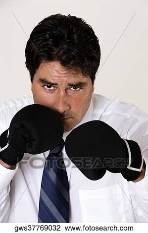 Portrait of a businessman wearing boxing gloves View Large Photo Image Stock Image - Portrait of a businessman wearing boxing gloves. Fotosearch