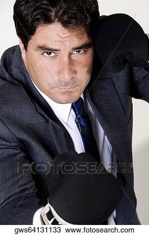 Portrait of a businessman wearing boxing gloves View Large Photo Image Stock Image - Portrait of a businessman wearing boxing gloves. Fotosearch