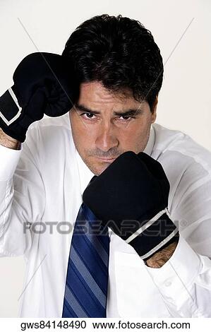 Portrait of a businessman wearing boxing gloves View Large Photo Image Stock Image - Portrait of a businessman wearing boxing gloves. Fotosearch