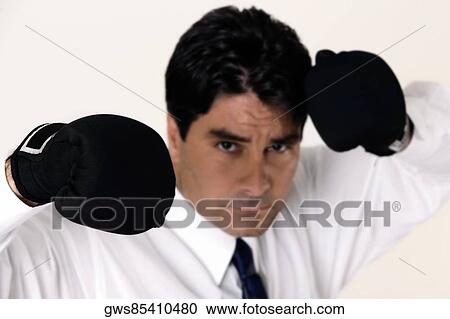 Portrait of a businessman wearing boxing gloves View Large Photo Image Stock Image - Portrait of a businessman wearing boxing gloves. Fotosearch