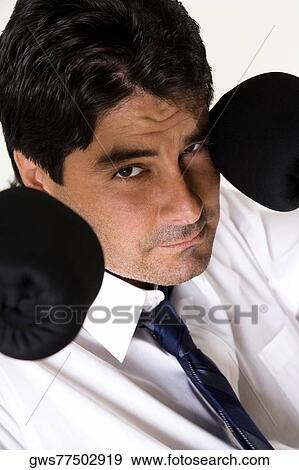 Portrait of a businessman wearing boxing gloves View Large Photo Image Stock Photo - Portrait of a businessman wearing boxing gloves. Fotosearch