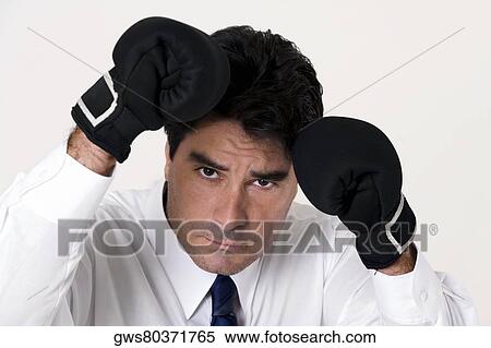 Portrait of a businessman wearing boxing gloves View Large Photo Image Stock Photography - Portrait of a businessman wearing boxing gloves. Fotosearch