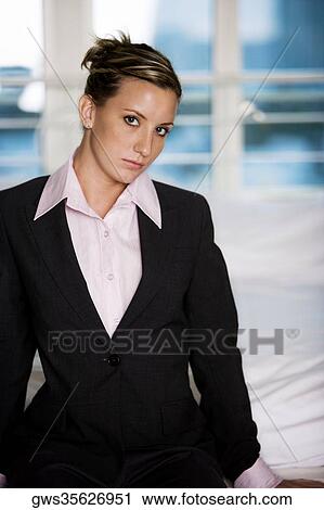 Portrait of a businesswoman sitting on the bed View Large Photo Image Stock Image - Portrait of a businesswoman sitting on the bed. Fotosearch
