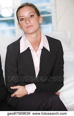Portrait of a businesswoman sitting on a bed View Large Photo Image Stock Photo - Portrait of a businesswoman sitting on a bed. Fotosearch
