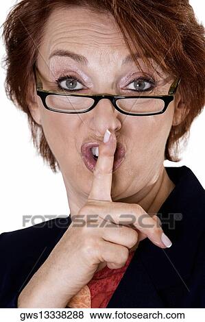 Stock Photo - Portrait of a businesswoman with her finger on her lips. Fotosearch
