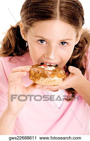 Portrait of a girl eating a donut View Large Photo Image Stock Image - Portrait of a girl eating a donut. Fotosearch