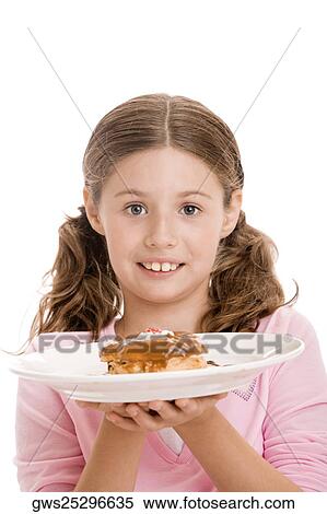 Stock Photography - Portrait of a girl holding a donut in a plate. Fotosearch