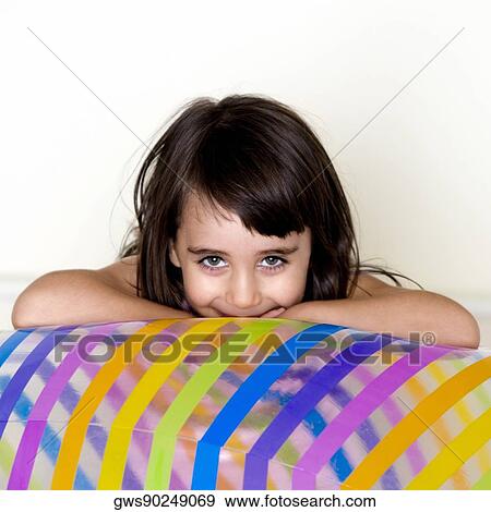 Stock Photo - Portrait of a girl leaning on an inflatable ball. Fotosearch
