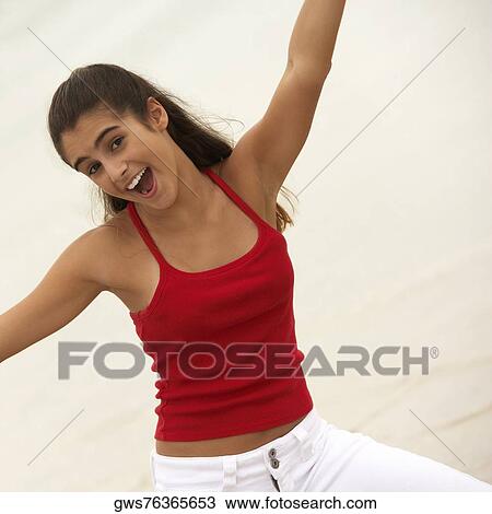 Portrait of a girl smiling with her arms raised View Large Photo Image Stock Image - Portrait of a girl smiling with her arms raised. Fotosearch