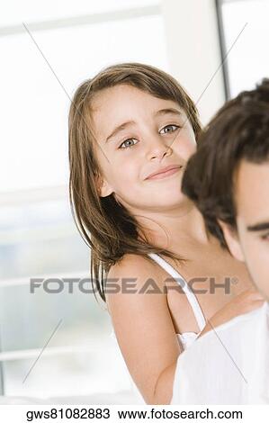 Portrait of a girl standing behind her father View Large Photo Image Stock Image - Portrait of a girl standing behind her father. Fotosearch