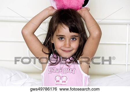 Portrait of a girl with her arms raised View Large Photo Image Stock Photograph - Portrait of a girl with her arms raised. Fotosearch
